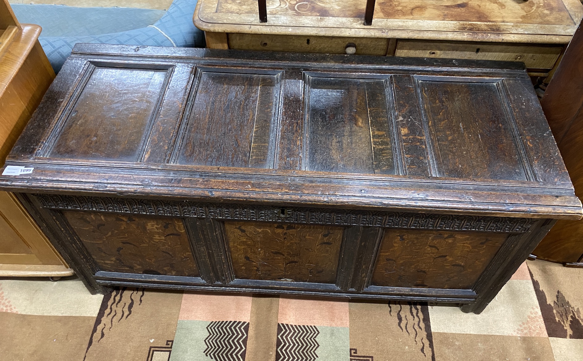 A 17th century inlaid oak panelled coffer, width 139cm, depth 56cm, height 64cm